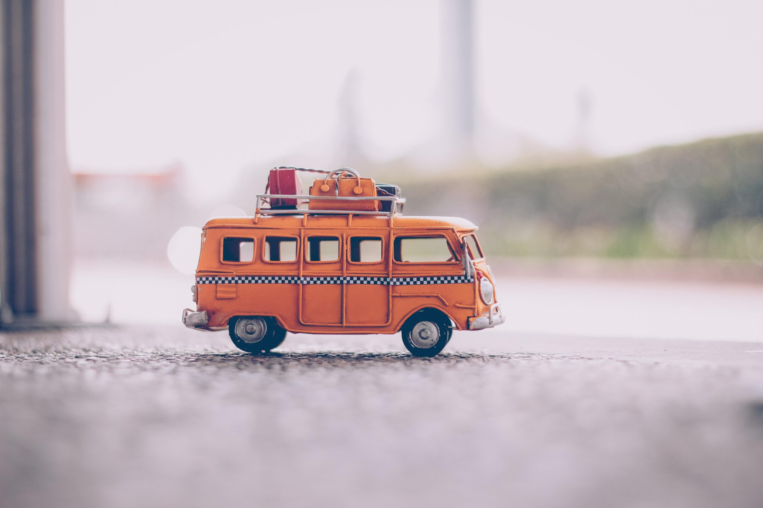 yellow, die-cast, school model bus on pavement.