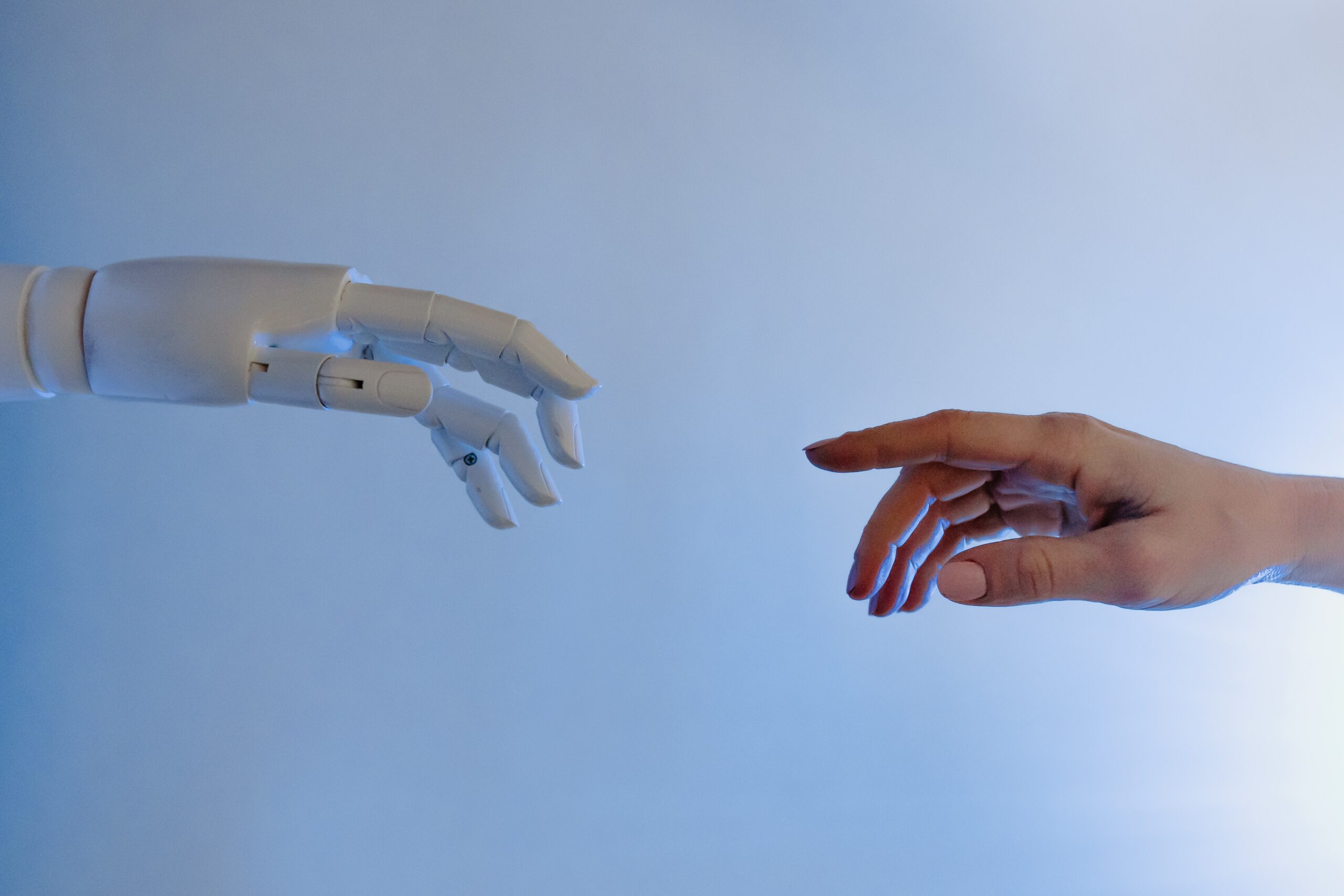 two hands one robotic one human