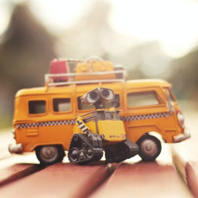 yellow toy bus and yellow toy robot